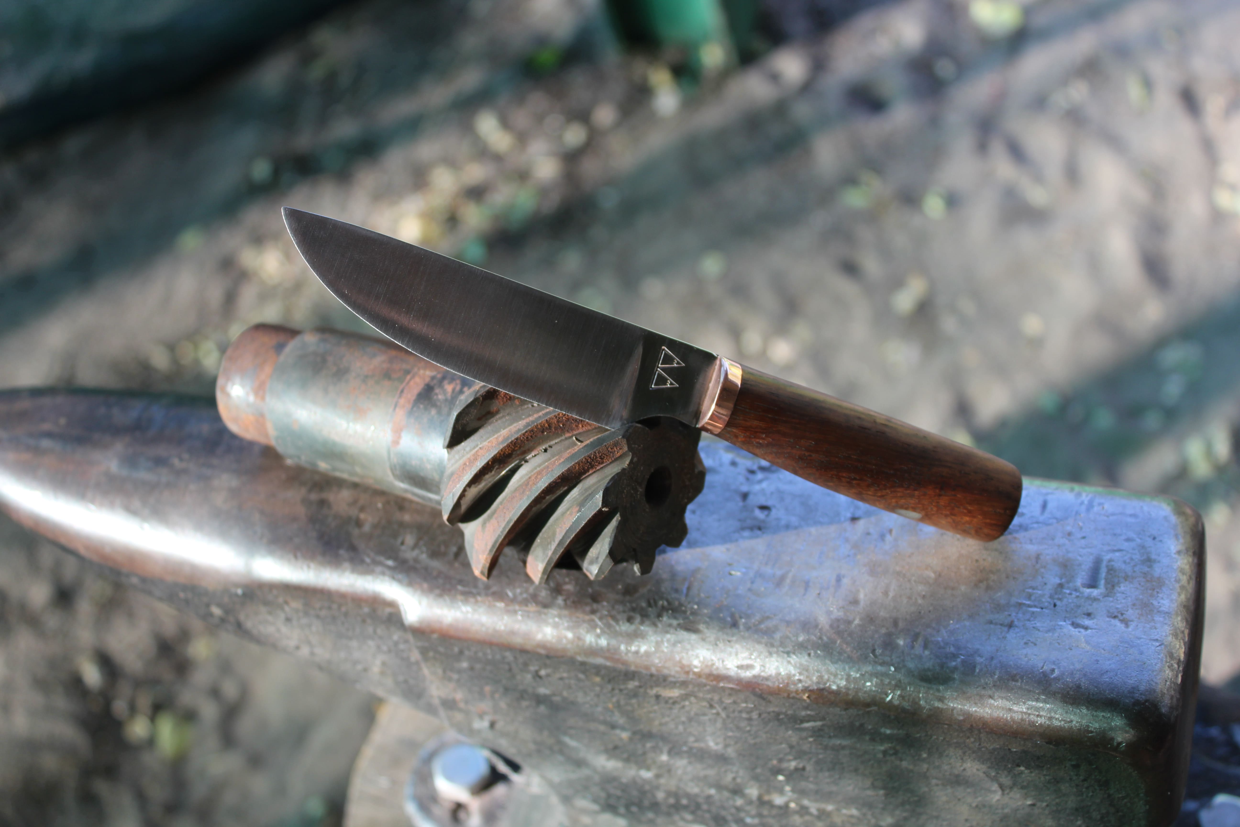 A custom skinning knife with a Mukwa handle and copper bolster.