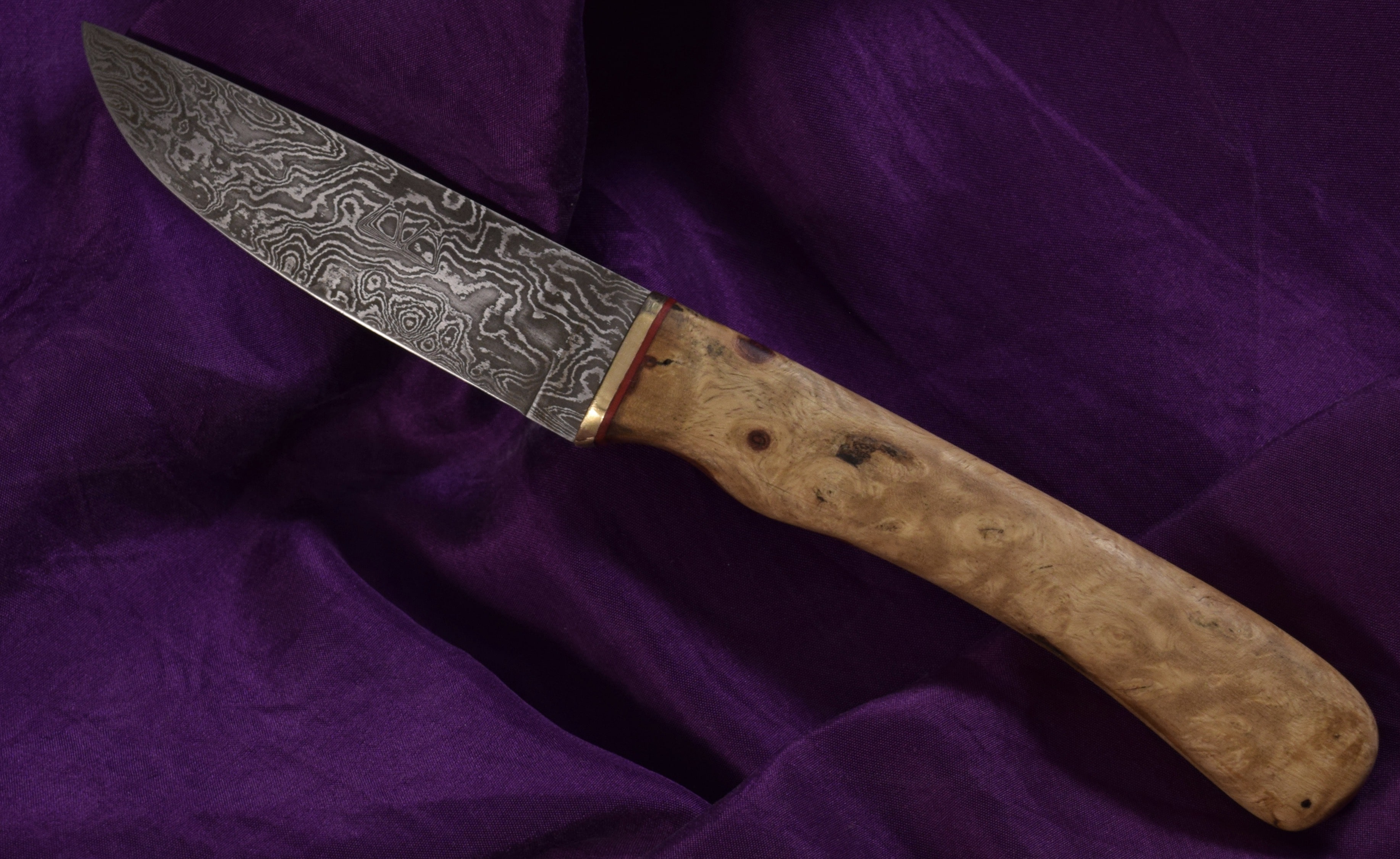 A 192-layer Damascus steel Bushbuck with an Amboyna burl handle.