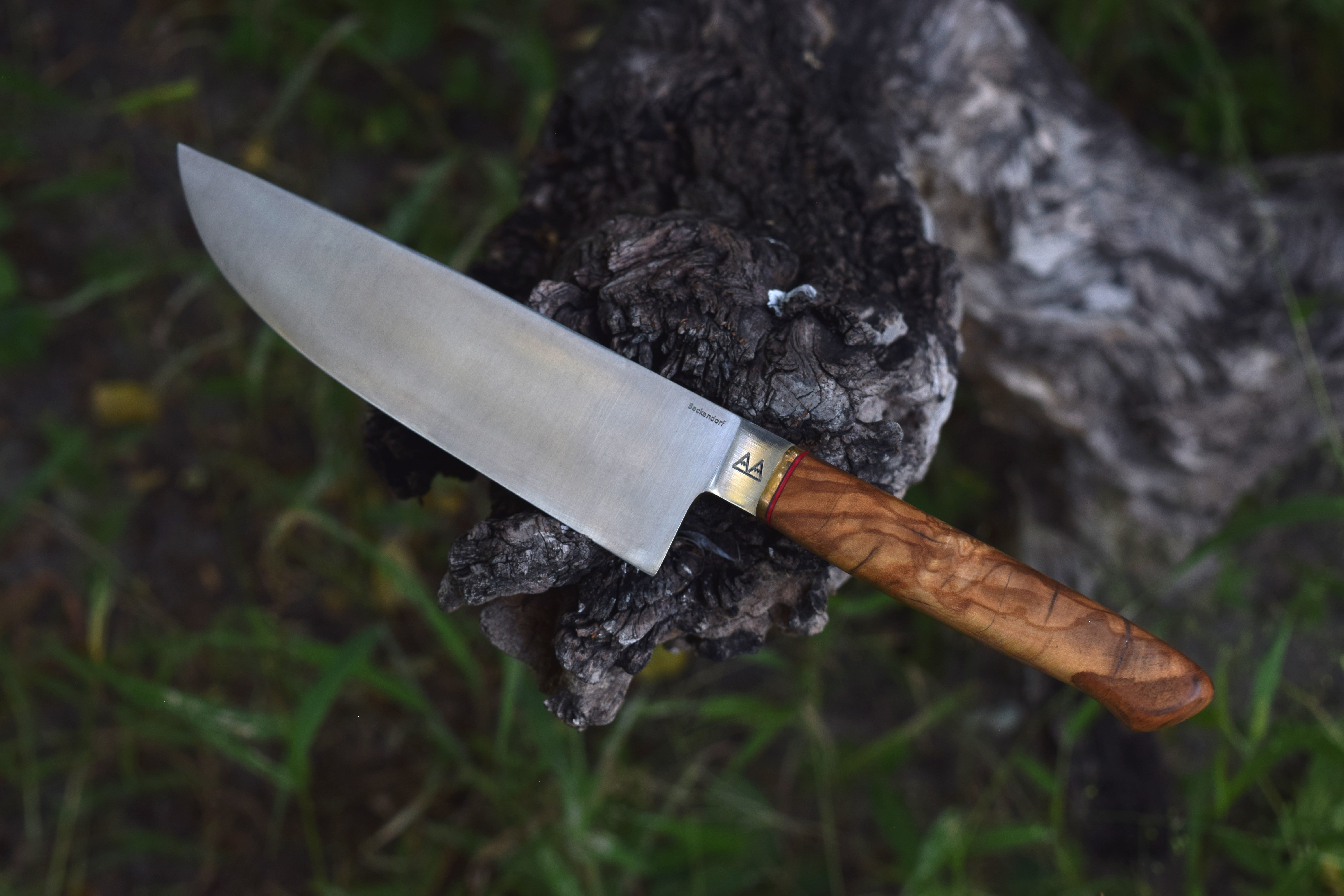 A chef's knife with an Olivewood handle.